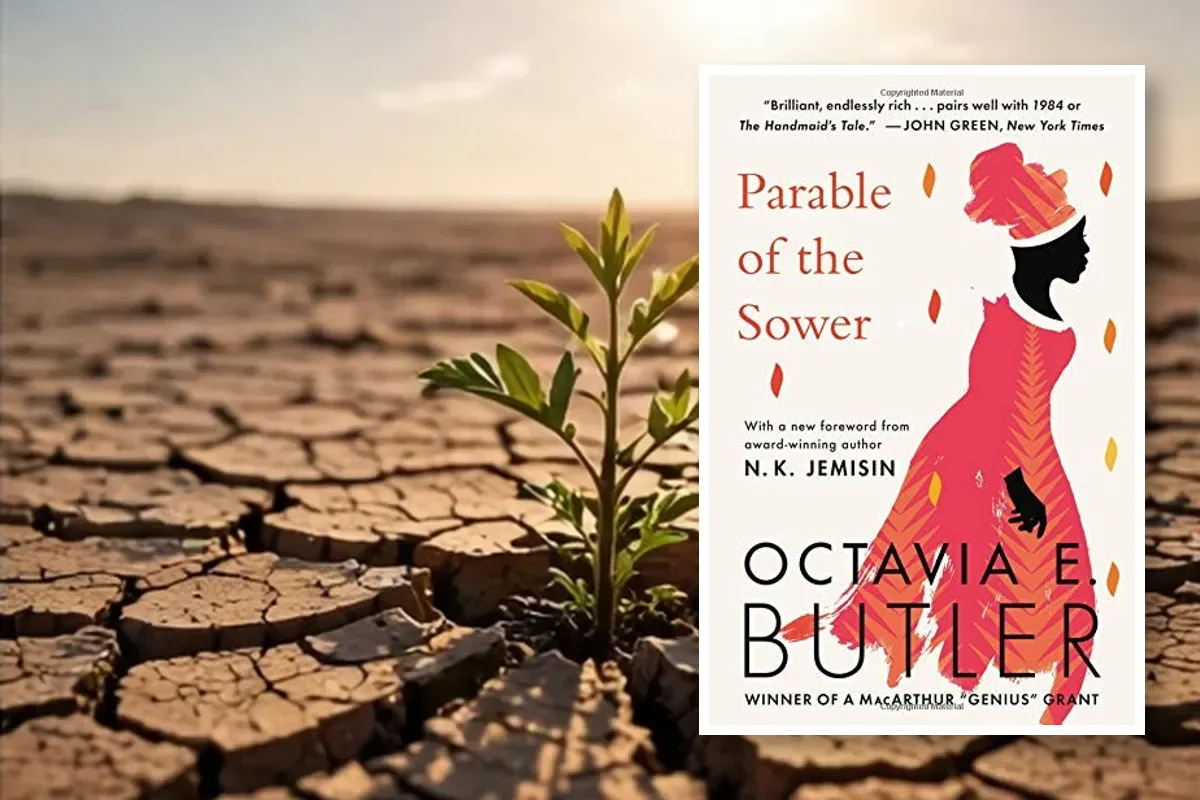 Parable of the Sower book cover by Octavia E. Butler placed over dry cracked earth with a young plant